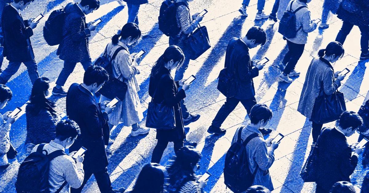 Crowd of people walking while using smartphones